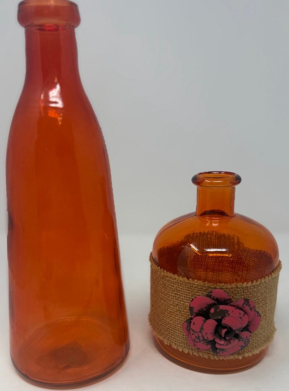 Orange Bottles Tall and Short with Burlap and a Metal Pink Flower
